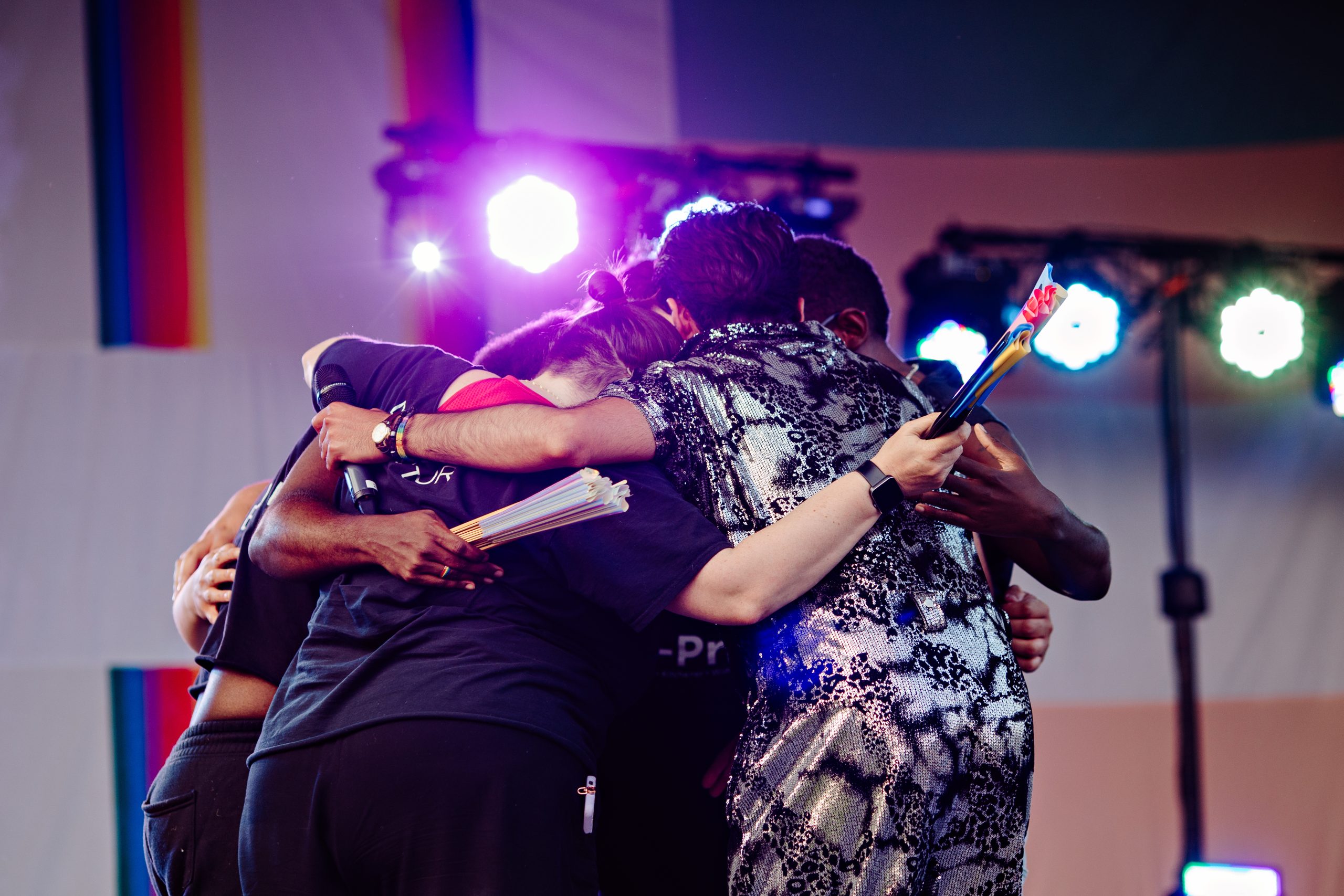 tri-Pride Board huddle at end of festival